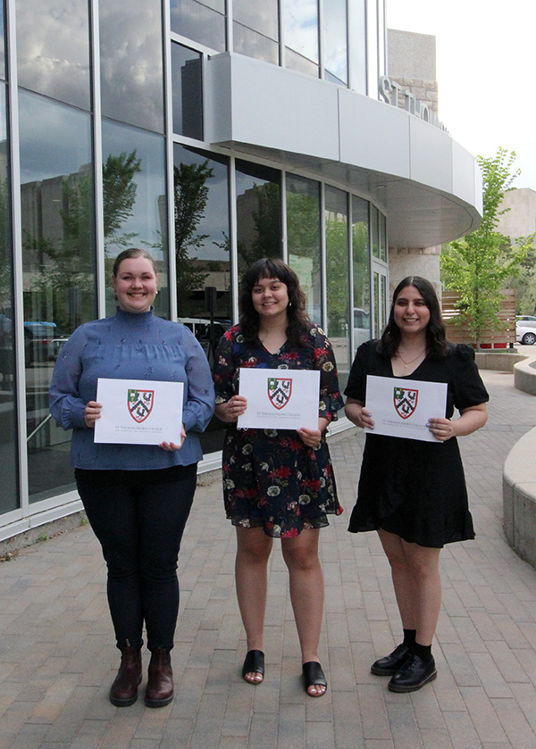 STM College Awards were presented Tuesday at the Spring 2022 Convocation Ceremony. Jessi Harms (from left) was awared the Thomas Deis '38 Prize in Scholastic Philosophy in Honour of Dr. Basil Markle S.T.D., Hannah Tran and Ana Cristina Camacho Alarcón were co-recipients of the Fr. Henry Carr Award, awarded to a student/students who has/have shown leadership in and/or contributed to the life of the St. Thomas More College